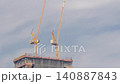 Building construction site daytime timelapse Dubai yellow tower cranes aerial 140887843