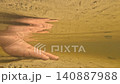 Human Hand Underwater on Sandy Riverbed in Shallow Water 140887988