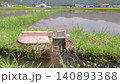 Agricultural irrigation canals flowing through rice paddies before rice planting. 140893388