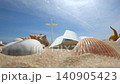 A church summer retreat, summer Bible school, and summer camp background featuring a Bible, a cross, seashells, and conch shells on a cool sandy beach. 140905423