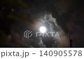A mystical night sky with a full moon shining brightly and clouds drifting by. 140905578