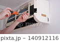 Hvac technician servicing and repairing an indoor air conditioner split system unit at home 140912116