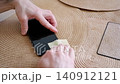 Male hands cleaning a mobile phone screen with a cloth before applying a protective tempered glass 140912121