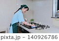 House cleaning staff cleaning the gas stove 140926786