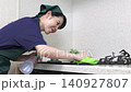 House cleaning staff cleaning the gas stove 140927807