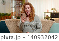 Pregnant young woman receiving good news on smartphone at home, expressing happiness and surprise 140932042