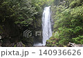 A powerful waterfall cascading down a steep dark rocky cliff 140936626