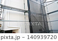 Exterior wall renovation work for a detached house: Temporary scaffolding and new siding. Exterior wall renovation work for a detached house: Temporary scaffolding and new siding. 140939720
