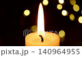 Warm candle flame flickering with golden bokeh lights 140964955