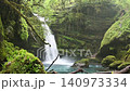 A powerful waterfall plunging into a clear turquoise pool 140973334