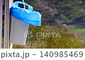 Trash can with plastic bag on caravan door 140985469