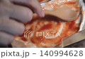 Spread tomato ketchup on the pizza dough. Spread tomato ketchup on the pizza dough. 140994628