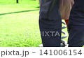 Child walking on a lush green lawn in a sunny park during a bright summer afternoon outdoor session 141006154