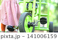 Child walking on a lush green lawn in a sunny park during a bright summer afternoon outdoor session 141006159