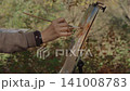 Close-up, the artist paints a forest landscape with watercolor on a sunny day 141008783