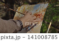 Artist Painting Autumn Watercolor Landscape In Forest On Sunny Day 141008785