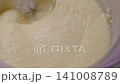 Mixer whips the butter mass to make milk cream 141008789