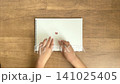 A child's hand sticking a dusty pink heart sticker into a notebook (4K silent video) 141025405
