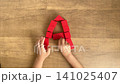 A series of 4K silent videos showing how to complete the letter A using red building blocks. 141025407