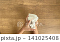 A child's hands crumpling up a piece of white paper - 4K silent slow-motion video 141025408