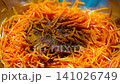 Preparing Fermented marinated carrot salad Sprinkle salad with red chili pepper  141026749