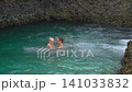 Mother and toddler swimming in beach rock pool by Caribbean Sea. Slow motion. 141033832