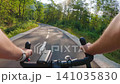POV of cyclist riding on asphalt bike path at sunset in summer 141035830