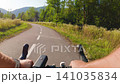 POV of cyclist riding on asphalt bike path at sunset in summer 141035834