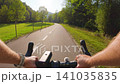 POV of cyclist riding on asphalt bike path at sunset in summer 141035835