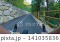 POV of cyclist riding on asphalt bike path at sunset in summer 141035836