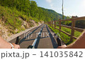 POV of cyclist riding on asphalt bike path at sunset in summer 141035842