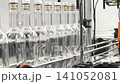 Bottles moving on a conveyor belt at a manufacturing plant during the daytime 141052081