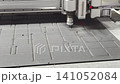 Laser cutting process in an industrial workshop, focusing on precision and design details during the procedure 141052084