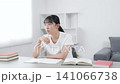 Teenage woman studying in a room 141066738