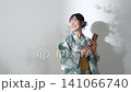 Portrait of a teenage girl wearing a yukata using a smartphone 141066740