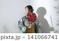 Teenage girl wearing a yukata 141066741