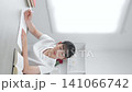 A teenage girl studying while looking at her smartphone 141066742