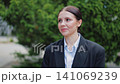 Young Businesswoman Smiles Confidently in Professional Attire Outdoors 141069239