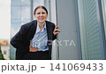 Painful Businesswoman Suffering From Abdominal Cramps Outdoors 141069433