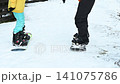 Two snowboarders getting ready on a snowy slope. Winter sports fun 141075786