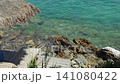 Waves crushing of beachfront wooden deck with sun loungers above rocky turquoise sea of Adriatic sea on Albanian RIviera 141080422