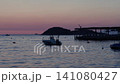 A small motorboat floating on calm waters at sunset along the Albanian Riviera 141080427