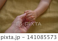 Red blister-like spots on child fingers and hand. Close-up. 141085573