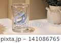 Dental retainer soaking in water with an effervescent cleaning tablet 141086765
