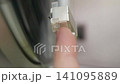 Lift the needle on the record player with your finger. 141095889