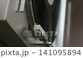 Listening to analog records on a record player 141095894