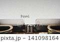 Old mechanical typewriter typing Equal Voice in a close up view, with metal letters striking the white paper. 141098164