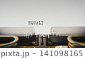 Old mechanical typewriter typing Equality For Allborder Control in a close up view, with metal letters striking the white paper. 141098165