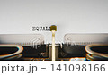 Old mechanical typewriter typing Equality in a close up view, with metal letters striking the white paper. 141098166