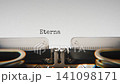 Old mechanical typewriter typing Eternal Questions in a close up view, with metal letters striking the white paper. 141098171
